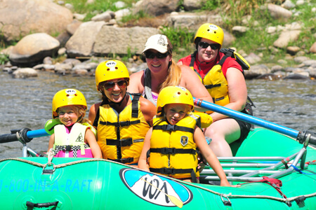 Four people inside of a green raft on mothers day