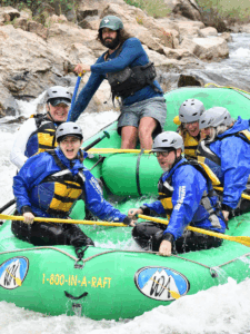 people rafting in a green boat