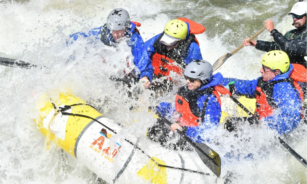 A yellow and white boat navigates white water