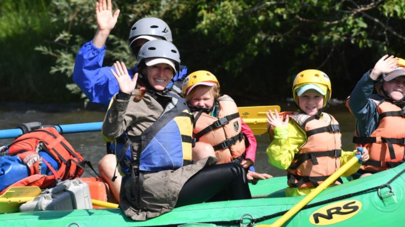 A family in a green raft on the river